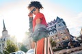 Outdoors Leisure. Young stylish african girl in denim jacket and sunglasses standing in sunlight posing confident bottom Royalty Free Stock Photo