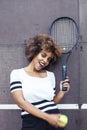 Young stylish afro-american girl playing tennis, sport healthy lifestyle people concept