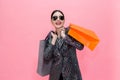 Young Stylish Asian woman carrying shopping bags and holding credit card. Beautiful fashionable woman with sunglasses isolated Royalty Free Stock Photo