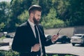 Young stylish bearded business man in a classy suit is browsing Royalty Free Stock Photo