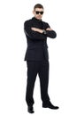 Young stylish bouncer in a black suit, arms folded Royalty Free Stock Photo