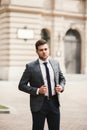 Young stylish businessman adjusting his suit, neck tie Royalty Free Stock Photo