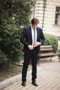 Young stylish businessman adjusting his suit, neck tie Royalty Free Stock Photo