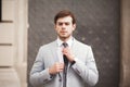 Young stylish businessman adjusting his suit, neck tie Royalty Free Stock Photo