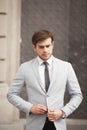 Young stylish businessman adjusting his suit, neck tie Royalty Free Stock Photo