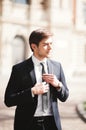 Young stylish businessman adjusting his suit, neck tie Royalty Free Stock Photo