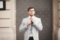 Young stylish businessman adjusting his suit, neck tie Royalty Free Stock Photo