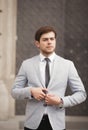 Young stylish businessman adjusting his suit, neck tie Royalty Free Stock Photo