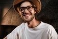 Young stylish cheerful man happily looking in camera in modern sound recording studio