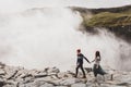 Young stylish couple in love in wool sweaters together near Dettifoss waterfall Royalty Free Stock Photo