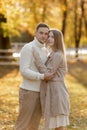 Young stylish couple lovers are hugging in the autumn park. Lovely romantic moment between man and woman in love. Happy Royalty Free Stock Photo