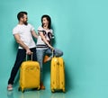 Young stylish couple man and woman in casual clothes are smiling posing with travel yellow suitcases Traveling Royalty Free Stock Photo