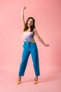Young stylish disco girl on pink background