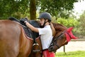 Rider tacking up her horse Royalty Free Stock Photo