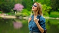 Young stylish girl have a rest near a pond Royalty Free Stock Photo