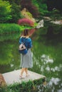 Young stylish girl have a rest near a pond Royalty Free Stock Photo