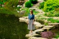 Young stylish girl have a rest near a pond Royalty Free Stock Photo