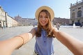 Young stylish girl takes selfie with mobile phone on summer city street urban lifestyle concept