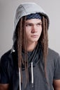 Young stylish guy with dreadlocks and wearing a hood.