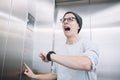 Young stylish guy standing in elevator