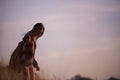 Young stylish hipster girl enjoy sunset on viewpoint. Travel woman with backpack Royalty Free Stock Photo