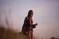 Young stylish hipster girl enjoy sunset on viewpoint. Travel woman with backpack Royalty Free Stock Photo