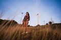 Young stylish hipster girl enjoy sunset on viewpoint. Travel woman with backpack Royalty Free Stock Photo