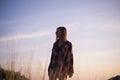 Young stylish hipster girl enjoy sunset on viewpoint. Travel woman with backpack Royalty Free Stock Photo