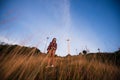 Young stylish hipster girl enjoy sunset on viewpoint. Travel woman with backpack Royalty Free Stock Photo