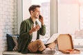 Young happy businessman talking mobile phone while working at home office Royalty Free Stock Photo