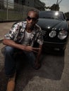 Young stylish male posing by a car Royalty Free Stock Photo