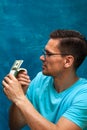 Young stylish man counting heaps of money Royalty Free Stock Photo