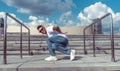 Young stylish man guy dancer, in the summer in the city, dancing break dance, healthy fitness athlete life style, white Royalty Free Stock Photo