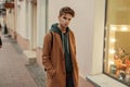 Young stylish man with a haircut in a fashionable vintage coat Royalty Free Stock Photo