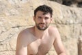 Young stylish man outdoor portrait near sea cave