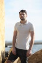 Young stylish man portrait dressed in white polo shirt and black shorts Royalty Free Stock Photo