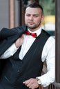 Young stylish man in a suit. Portrait of the groom. The groom is holding his jacket on his shoulder Royalty Free Stock Photo