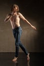 Young and stylish modern dancer on grey background Royalty Free Stock Photo