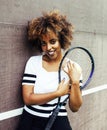 Young stylish mulatto afro-american girl playing tennis, sport h
