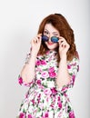 Young stylish red-haired woman with curly hair and pretty face posing in sunglasses. expresses different emotions Royalty Free Stock Photo