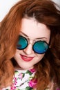 Young stylish red-haired woman with curly hair and pretty face posing in sunglasses. expresses different emotions Royalty Free Stock Photo