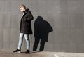 Young stylish redhead man in trendy outfit posing against urban background Royalty Free Stock Photo