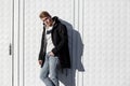 Young stylish redhead man in trendy outfit posing against urban background Royalty Free Stock Photo