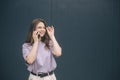 Young stylish trendy woman isolated over grey blue background. Cheerful girl talking on phone and smiling. Conversation