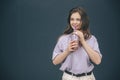 Young stylish trendy woman isolated over grey blue background. Lovely amazing girl drinking lemonade and posing on Royalty Free Stock Photo