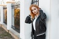 Young stylish woman with beautiful eyes in a black summer stylish jacket in black jeans in a white polo shirt Royalty Free Stock Photo