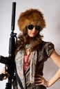 Young stylish woman with a gun Royalty Free Stock Photo