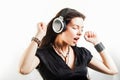Young stylish woman in large headphones listening to music and having fun. Royalty Free Stock Photo