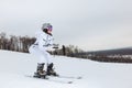 Young stylish woman learning to ski in downhill slope