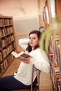 Portrait of young beautiful fashionable lady posing in library